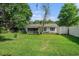 Green backyard featuring a screened-in porch, storage shed, and well-maintained lawn at 4311 Bradford Circle, Myrtle Beach, SC 29588