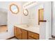 Well-lit bathroom with large mirrors, wood vanity, and modern fixtures for a clean aesthetic at 4311 Bradford Circle, Myrtle Beach, SC 29588