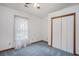 Bedroom featuring a ceiling fan, carpeted floors, a window with lace curtains, and a double closet at 4311 Bradford Circle, Myrtle Beach, SC 29588