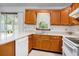 Bright kitchen with ample counter space, wood cabinets, and modern fixtures overlooking the backyard at 4311 Bradford Circle, Myrtle Beach, SC 29588