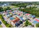 High angle of vibrant residential community featuring colorful homes, pool, and lush greenery at 4338 Grande Harbour Blvd., Little River, SC 29566