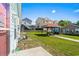 Spacious backyard featuring a gazebo, lush green lawn, and views of neighboring homes under a clear sky at 4338 Grande Harbour Blvd., Little River, SC 29566