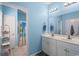 Bathroom featuring double sinks with white cabinetry and tile flooring at 4338 Grande Harbour Blvd., Little River, SC 29566