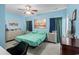 Calm bedroom features blue walls, ceiling fan, a bed, and dresser creating a serene atmosphere at 4338 Grande Harbour Blvd., Little River, SC 29566