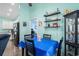 Bright dining area featuring a blue table, shelving, and convenient access to the kitchen at 4338 Grande Harbour Blvd., Little River, SC 29566