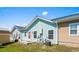 Exterior view of light blue home featuring multiple windows, air conditioning unit, and well-maintained yard at 4338 Grande Harbour Blvd., Little River, SC 29566