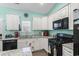 Bright kitchen features white cabinetry, granite countertops and stainless steel appliances at 4338 Grande Harbour Blvd., Little River, SC 29566