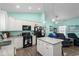 Stylish kitchen with white cabinets, a central island, and an open view into the dining and living areas at 4338 Grande Harbour Blvd., Little River, SC 29566