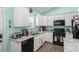 Well-lit kitchen featuring white cabinets, granite countertops, stainless steel appliances, and modern fixtures at 4338 Grande Harbour Blvd., Little River, SC 29566