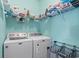 A well-equipped laundry room with a washer, dryer, and ample shelving for storage at 4338 Grande Harbour Blvd., Little River, SC 29566