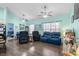 Open-concept living room with modern furniture, light teal walls, and stylish ceiling fans at 4338 Grande Harbour Blvd., Little River, SC 29566