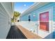 Side view showcasing the wood deck and light blue siding of the charming coastal home at 4338 Grande Harbour Blvd., Little River, SC 29566