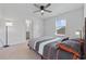 Well-lit bedroom featuring neutral walls, a ceiling fan, and a comfortable bed with stylish bedding at 4410 Honir Dr., Myrtle Beach, SC 29579