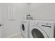 Functional laundry room equipped with a washer, dryer, wire shelving, and clean white walls at 4410 Honir Dr., Myrtle Beach, SC 29579