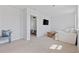 Bright living room featuring neutral walls, carpet, a TV, and access to an adjacent bedroom at 4410 Honir Dr., Myrtle Beach, SC 29579