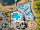 Aerial view of a luxurious community pool area with water features and lounge chairs at 4410 Honir Dr., Myrtle Beach, SC 29579