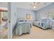 Light blue bedroom featuring two twin beds with nautical-themed bedding, a ceiling fan, and natural light from a window at 444 Dornoch Dr., Pawleys Island, SC 29585