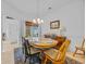 Cozy dining room with an oval table, neutral wall, and a chandelier, creating a warm, inviting space at 444 Dornoch Dr., Pawleys Island, SC 29585