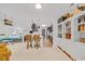 Open-concept living area with wicker furniture, carpet, and a kitchen featuring dark cabinets and bar seating at 444 Dornoch Dr., Pawleys Island, SC 29585