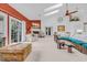 Sunlit living room features a cozy fireplace, glass doors and comfortable seating at 444 Dornoch Dr., Pawleys Island, SC 29585