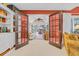 Inviting living room with french doors, leading to a cozy sitting area with ample natural light and comfortable seating at 444 Dornoch Dr., Pawleys Island, SC 29585