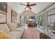 Bright living room with vaulted ceiling, sliding glass doors and large windows offering lots of natural light at 444 Dornoch Dr., Pawleys Island, SC 29585