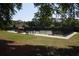 Well-maintained community tennis court with a seating area for enjoying a match at 444 Dornoch Dr., Pawleys Island, SC 29585