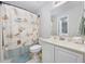Bright bathroom features a seashell-themed shower curtain and a white vanity with a large mirror at 4506 West Harbor Ct. # U-15, Little River, SC 29566