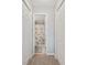 Hallway view of a bathroom, featuring a shower/bath, toilet, and a decorative shower curtain at 4506 West Harbor Ct. # U-15, Little River, SC 29566