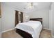 Clean bedroom with a wood frame bed, side table with lamp, and soft, natural lighting at 4506 West Harbor Ct. # U-15, Little River, SC 29566