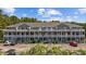 Attractive condo building featuring multi-level balconies, well-manicured landscaping, and convenient parking at 4506 West Harbor Ct. # U-15, Little River, SC 29566