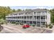 Condo building featuring multi-level balconies, well-manicured landscaping, and convenient parking at 4506 West Harbor Ct. # U-15, Little River, SC 29566