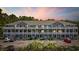 Attractive condo building featuring multi-level balconies, well-manicured landscaping, and convenient parking at 4506 West Harbor Ct. # U-15, Little River, SC 29566