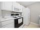 Bright kitchen featuring white cabinets and appliances with a black range at 4506 West Harbor Ct. # U-15, Little River, SC 29566