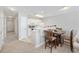 Kitchen area with white appliances, half wall and adjacent table with seating at 4506 West Harbor Ct. # U-15, Little River, SC 29566