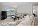 Inviting living room features comfortable seating, a ceiling fan, and balcony access with a view at 4506 West Harbor Ct. # U-15, Little River, SC 29566
