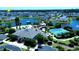 Aerial view of the gated community with ponds, pool, tennis courts, and landscaping at 451 W Palm Dr., Myrtle Beach, SC 29579