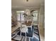 Inviting dining area with a wooden table, white chairs, and decorative lighting at 451 W Palm Dr., Myrtle Beach, SC 29579