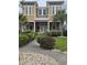 Charming two-story home with a landscaped yard, inviting front porch, and classic architectural details at 451 W Palm Dr., Myrtle Beach, SC 29579