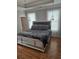Elegant main bedroom features a decorative bed, hardwood floors, and natural light from the window at 451 W Palm Dr., Myrtle Beach, SC 29579