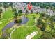 Aerial view of condos on a lush green golf course near a pond at 4705 Wild Iris Dr. # 305, Myrtle Beach, SC 29577
