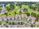 Aerial view of condo community with parking, landscaping, and golf course at 4705 Wild Iris Dr. # 305, Myrtle Beach, SC 29577