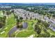 Beautiful aerial view of community condos on golf course with lush green grass and ponds at 4705 Wild Iris Dr. # 305, Myrtle Beach, SC 29577