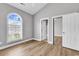 Bright bedroom features wood-look flooring, arched window and a closet at 4705 Wild Iris Dr. # 305, Myrtle Beach, SC 29577