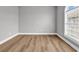 Bedroom featuring wood-look flooring, arched window and grey walls at 4705 Wild Iris Dr. # 305, Myrtle Beach, SC 29577