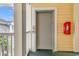 Building elevator with safety features, adjacent to yellow siding and white trim at 4705 Wild Iris Dr. # 305, Myrtle Beach, SC 29577