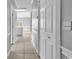 Neutral-toned hallway with closet, leading to a kitchen and living area with natural light at 4705 Wild Iris Dr. # 305, Myrtle Beach, SC 29577