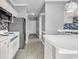 View of kitchen that features stainless steel appliances, white cabinets and tile floors at 4705 Wild Iris Dr. # 305, Myrtle Beach, SC 29577