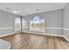 Bright, airy living room with hardwood floors and large windows showcasing natural light at 4705 Wild Iris Dr. # 305, Myrtle Beach, SC 29577