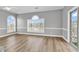 Bright, airy living room with hardwood floors and large windows showcasing natural light at 4705 Wild Iris Dr. # 305, Myrtle Beach, SC 29577
